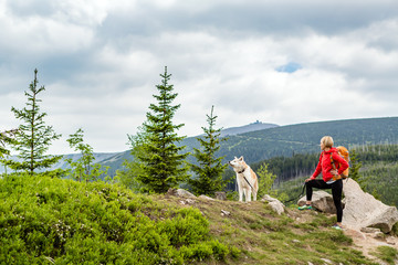 Happy woman hiking walking with dog in mountains, Poland - 165898590