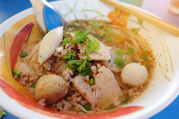 Pork Chop and fish ball Noodles, hot and sour soup, thai food