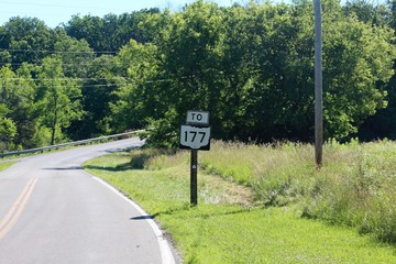 The route sign on the winding road. 