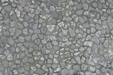 Stone pavement detail with background of small stone tiles