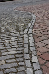 texture of stone pavement tiles cobblestones bricks in Pecs, Hungary