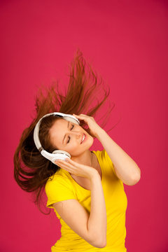 Beautiful young woman listen to the music over vibrant color background