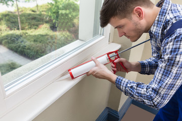 Worker Applying Silicone Sealant With Silicone Gun