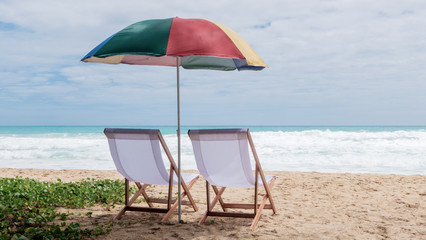 White beach chairs and umbrellas on Karon Beach, Phuket, Thailand