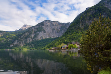 Naklejka na ściany i meble Scenic picture-postcard view of traditional old wooden houses in famous Hallstatt mountain village at Hallstattersee lake in the Austrian Alps in summer, region of Salzkammergut, Austria
