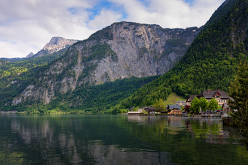 Scenic picture-postcard view of traditional old wooden houses in famous Hallstatt mountain village at Hallstattersee lake in the Austrian Alps in summer, region of Salzkammergut, Austria