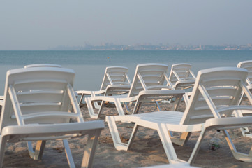 Sunbeds at sunrise on the seaside