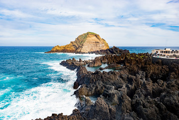 Ocean wave breaking sea water rocky shore rough seas turquoise water gradient foam background Porto Moniz Madeira