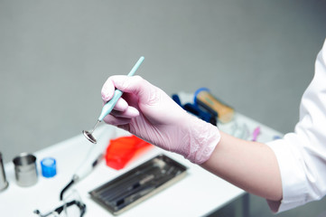 Dentist doctor hand holding medical tools in dental office. Concept of healthy