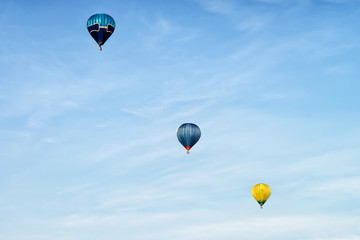 Blue and yellow colored hot air balloons at sky Vilnius