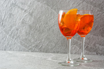 Aperol spritz cocktail in glass on gray stone
