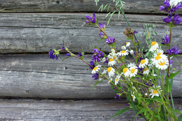 Bouquet of wildflowers on wooden background