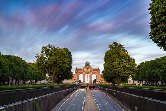 Dramatic view of the Triumphal Arch and Belliard Tunnel in Park Cinquantenaire in Brussels during sunset