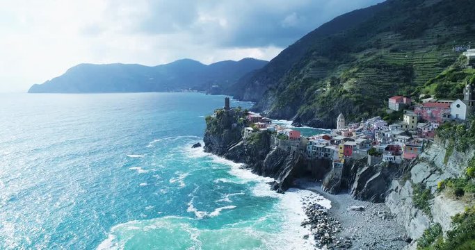 aerial view of travel landmark destination Vernazza,small mediterranean sea town,Cinque terre National Park, Liguria, Italy. Afternoon sunny and cloud weather. 4k slow motion 60 fps drone orbit video