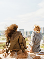 Two female friends enjoy city skyline