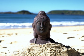 Buddha in sand at beach