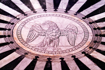 Marble floor with eagle as Cathedral interior in Siena