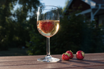 Sparkling wine and strawberries in a garden