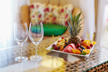 Hotel living room and bedroom furnished with rattan furniture and decorated for guests