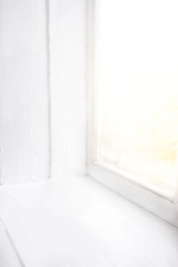 Closed white vintage window with sunlight on background, with empty copy space for your text..