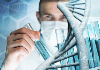 Young scientist mixing reagents in glass flask in clinical laboratory
