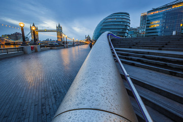 London, England - Tower Bridge and office buildings on a rainy day at blue hour