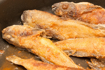 Fried fish in a frying pan