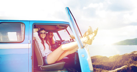 happy hippie women in minivan car on summer beach