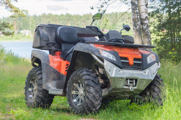 off-road motorcycle is on the road in a wooded area.