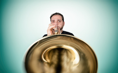Funny man is playing trumpet