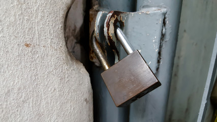  Locked rusty padlock on old wooden door