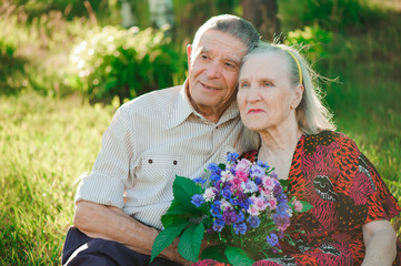 beautiful happy eighty years old people sitting in the  park