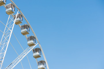 Detail of a ferris wheel against blue sky