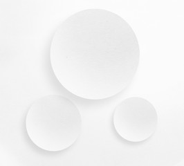 White paper circle with shadow on white background, copy space