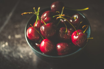 cherries berries in black bowl , vintage style