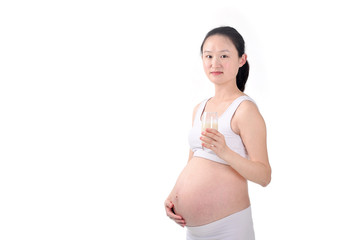 Pregnant woman holding glass of milk, isolated on white background
