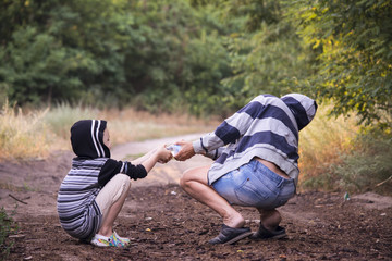 Boy and woman arguing from behind the water