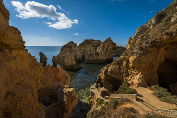 Fototapeta na wymiar Small bay between the sandstone cliffs at the Ponta da Piedade in Lagos, Portugal