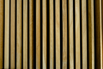 Vertical golden oak panels in wall cladding