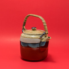 Japanese teapot red background