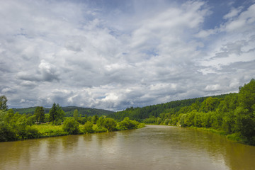 Fototapeta na wymiar summer day landscape river, mountains, cloudy sky