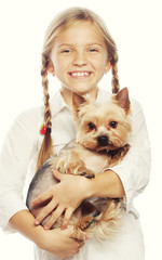 Portrait of an adorable young girl smiling holding a cute puppy 