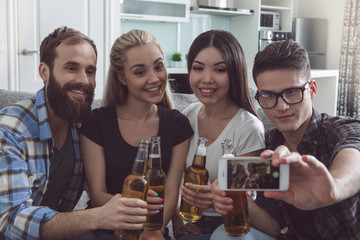 Group of friends having party together at home