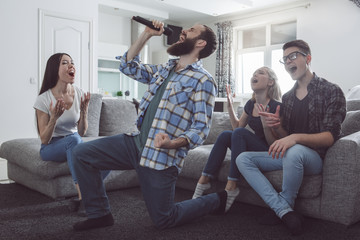 Group of friends having party together at home