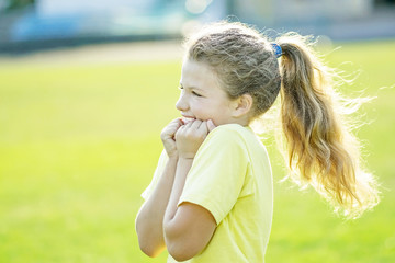 little girl overflowing with joyful emotions making sport activities at summer