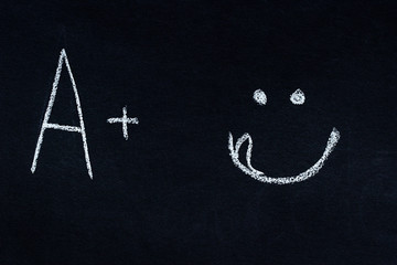 Letter and symbol written in white chalk