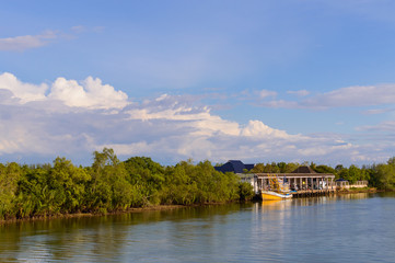 Fototapeta premium Boats at the river near pier of private house on the bank of river