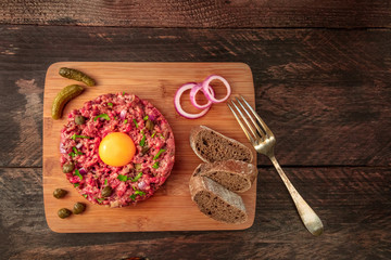 Closeup of steak tartare with garnish, and copyspace