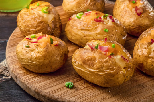 Closeup of baked potatoes with cheese and bacon