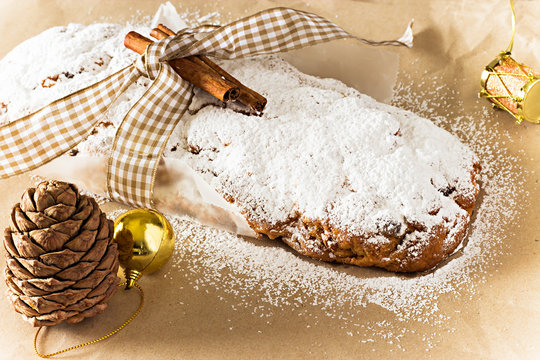 Christmas Stollen. Traditional German festive cake with nuts and dried fruits. Top view. Toned photo. Selective focus